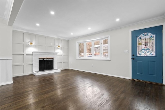 unfurnished living room with crown molding, a brick fireplace, dark hardwood / wood-style floors, and built in features