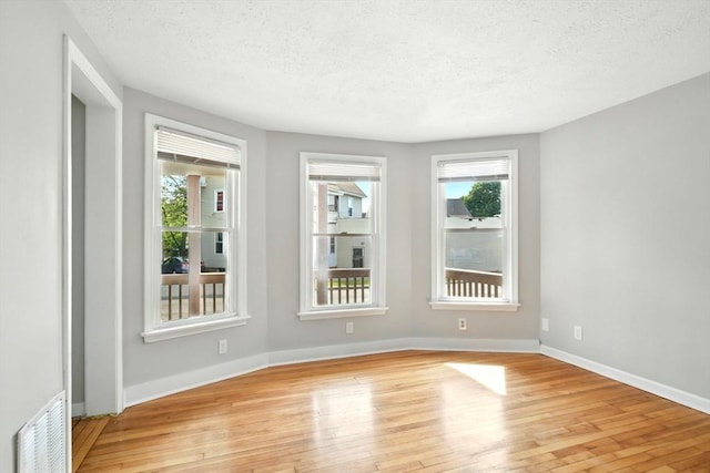 12-14 Kendall St, Springfield, MA 01104 - empty room with a textured ceiling, light wood-style flooring, and baseboards