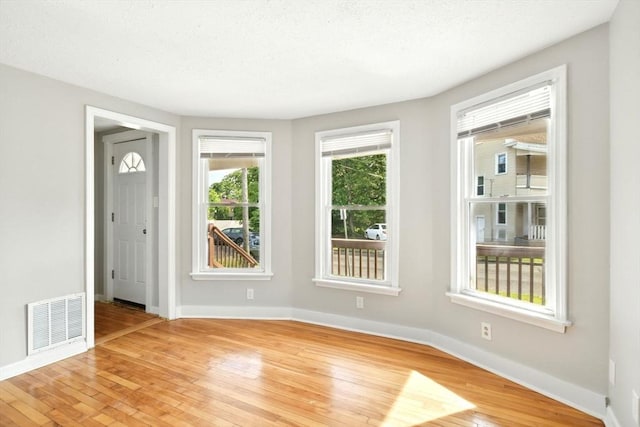12-14 Kendall St, Springfield, MA 01104 - spare room with light wood finished floors, baseboards, and a textured ceiling