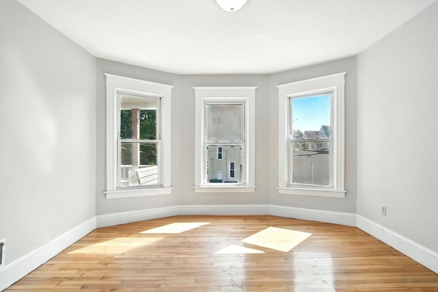 12-14 Kendall St, Springfield, MA 01104 - empty room with plenty of natural light, baseboards, and light wood-style flooring