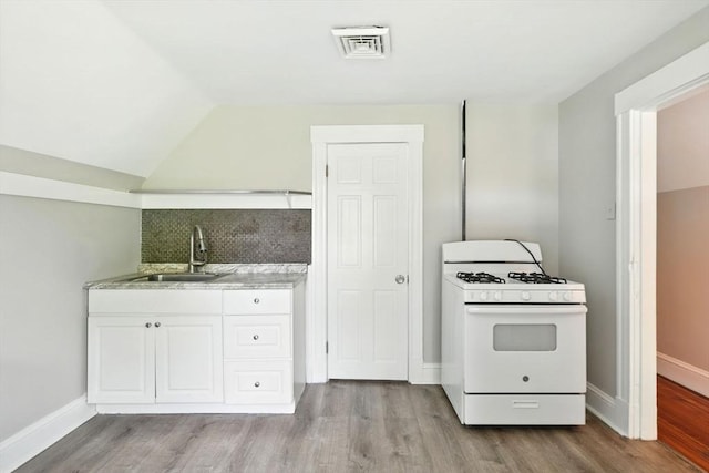 12-14 Kendall St, Springfield, MA 01104 - kitchen featuring white gas range oven, a sink, wood finished floors, light countertops, and white cabinetry