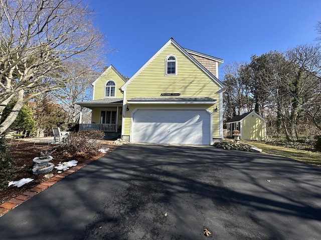 view of front of house featuring a porch and a garage