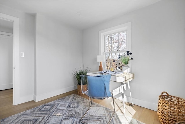 office featuring baseboards and wood finished floors