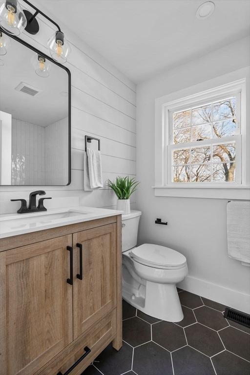 bathroom with visible vents, toilet, vanity, and tile patterned flooring