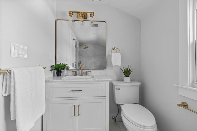 bathroom featuring visible vents, vanity, toilet, and a shower