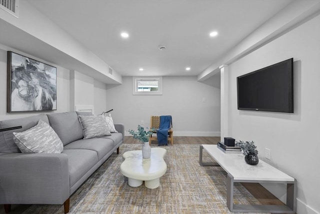 living area with visible vents, recessed lighting, baseboards, and wood finished floors