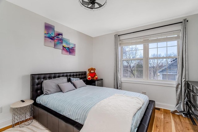 bedroom featuring baseboards and light wood-type flooring