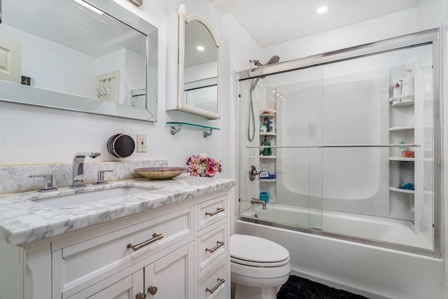 bathroom featuring vanity, toilet, recessed lighting, and shower / bath combination with glass door