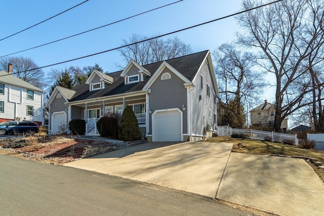 cape cod home featuring a porch and fence