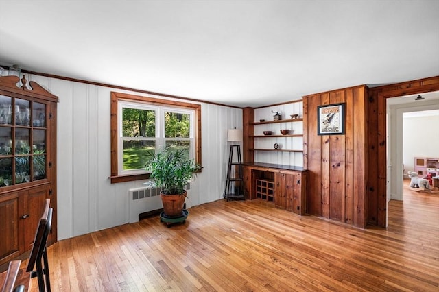 13 Clarks Rd, Amesbury, MA 01913 - living room featuring radiator, light wood-type flooring, crown molding, and wood walls