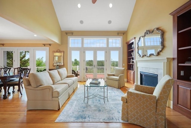 55 Maplecroft Ln Unit 55, Ipswich, MA 01938 - living area with high vaulted ceiling, french doors, a tiled fireplace, light wood-type flooring, and recessed lighting