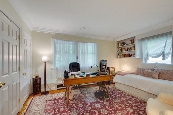 home office with crown molding and wood finished floors