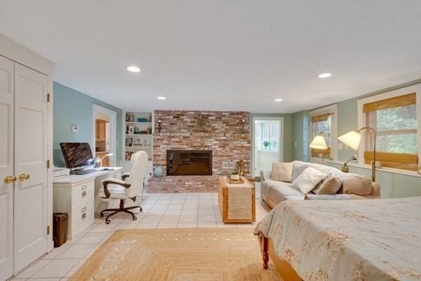 bedroom with recessed lighting, a fireplace, and light tile patterned flooring