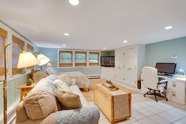 living area with a baseboard radiator, recessed lighting, and light tile patterned flooring