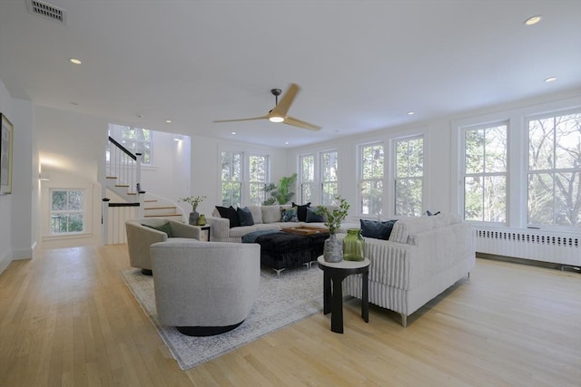 living room with radiator and light hardwood / wood-style floors