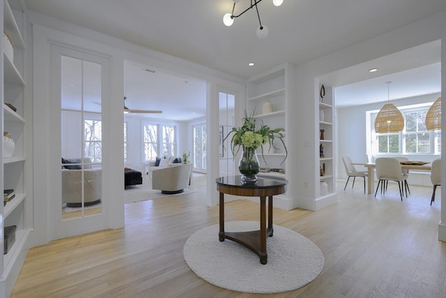 interior space with ceiling fan and light hardwood / wood-style flooring