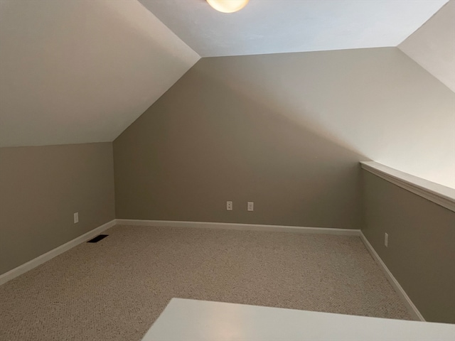 bonus room featuring lofted ceiling and carpet flooring