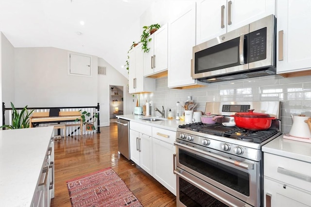 kitchen featuring a sink, stainless steel appliances, and light countertops