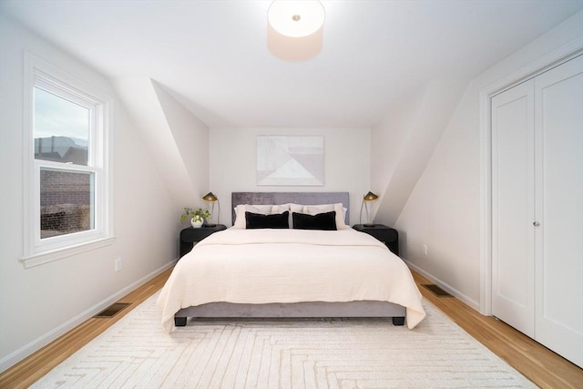 bedroom featuring light wood-type flooring and baseboards