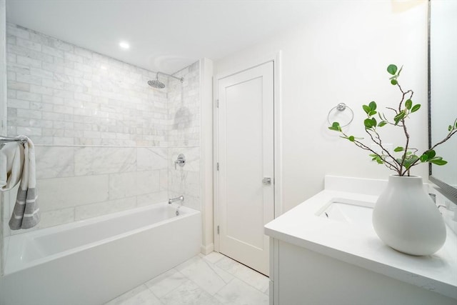 bathroom featuring marble finish floors, washtub / shower combination, vanity, and recessed lighting