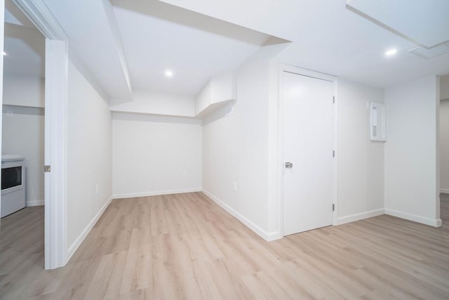 additional living space with wood finished floors, baseboards, recessed lighting, and washer / dryer