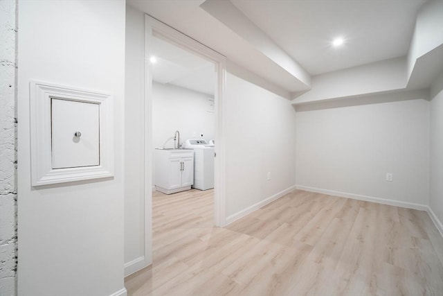 bonus room featuring washer / clothes dryer, light wood finished floors, and baseboards