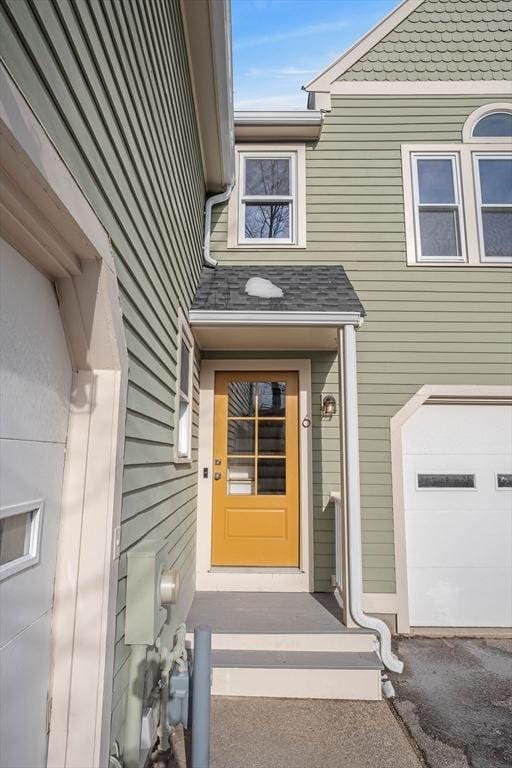 doorway to property featuring an attached garage