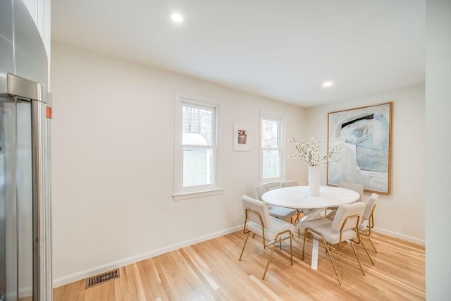 dining space with baseboards, light wood-style flooring, and recessed lighting