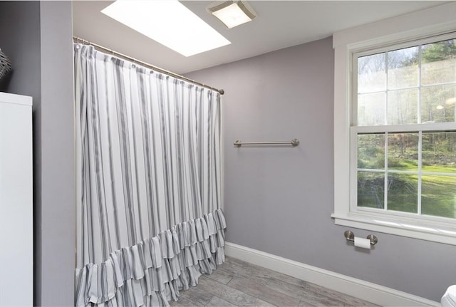 full bath featuring wood finished floors, visible vents, baseboards, and a shower with curtain