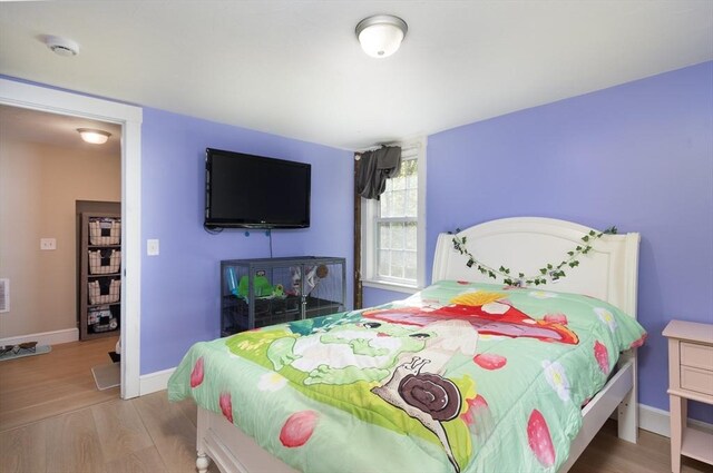 bedroom featuring baseboards and wood finished floors