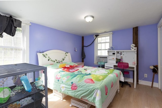 bedroom with baseboards and wood finished floors