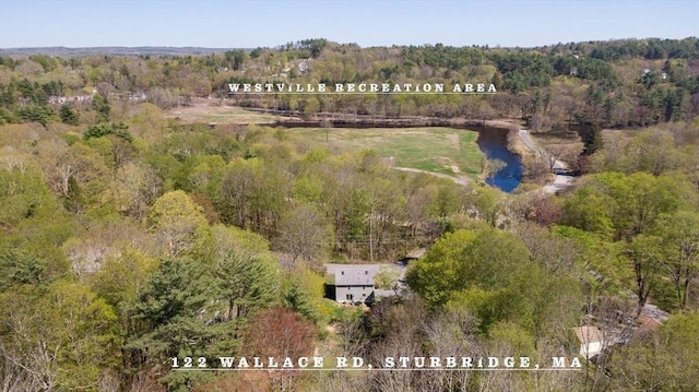 birds eye view of property with a wooded view