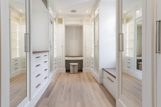 mudroom featuring crown molding, light wood finished floors, and recessed lighting