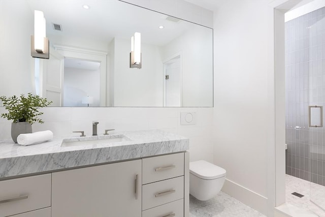 bathroom with vanity, baseboards, toilet, visible vents, and a tile shower