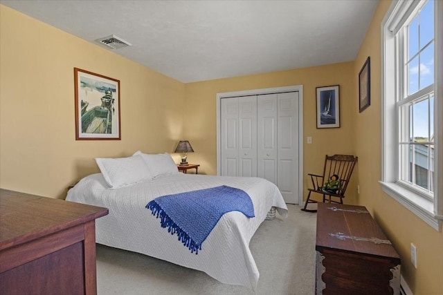 carpeted bedroom with multiple windows, a closet, and visible vents