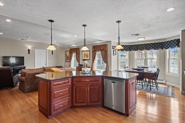 kitchen with a center island, open floor plan, light wood-style flooring, and dishwasher