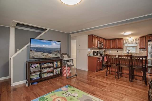 dining area featuring baseboards and wood finished floors