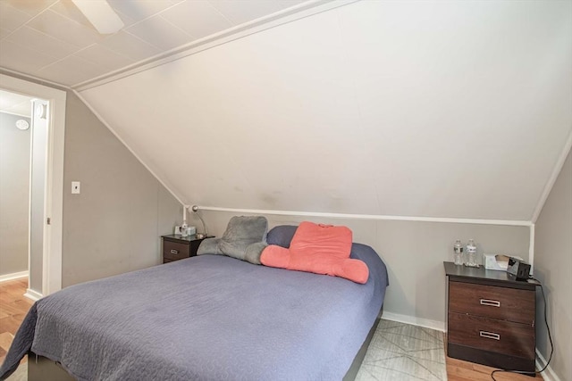 bedroom featuring vaulted ceiling and baseboards