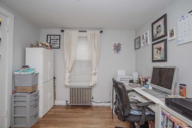 home office featuring radiator heating unit and wood finished floors