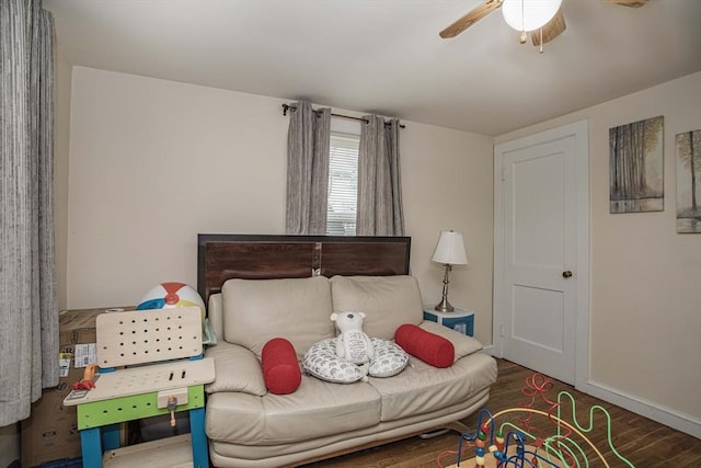 bedroom featuring a ceiling fan, baseboards, and wood finished floors