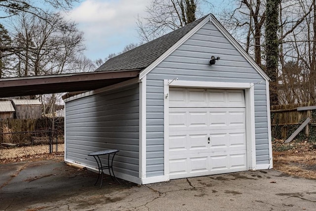 garage featuring a garage and fence