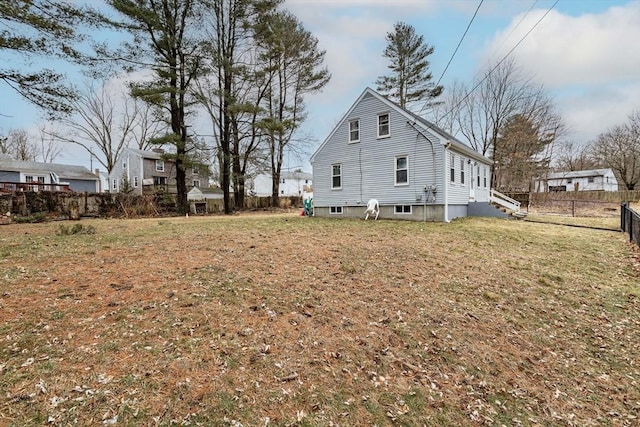 view of property exterior featuring a yard and fence