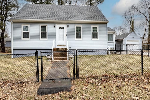 view of front of property featuring entry steps, a shingled roof, a detached garage, a gate, and a front lawn