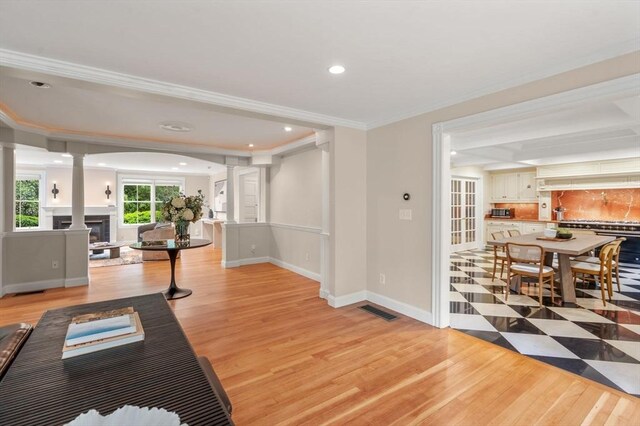 51 Summer St, Weston, MA 02493 - living room featuring light wood-style floors, a fireplace, decorative columns, baseboards, and ornamental molding