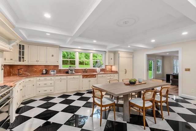 51 Summer St, Weston, MA 02493 - kitchen with healthy amount of natural light, tasteful backsplash, a sink, recessed lighting, and glass insert cabinets