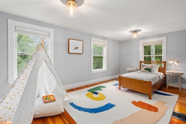 51 Summer St, Weston, MA 02493 - bedroom featuring multiple windows, baseboards, and wood finished floors