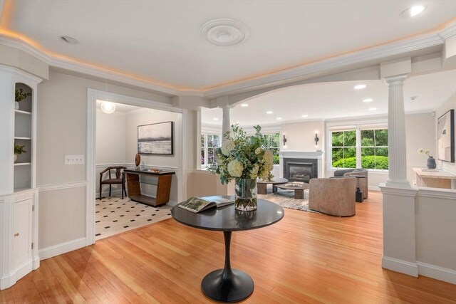 51 Summer St, Weston, MA 02493 - living area with decorative columns, light wood-style floors, crown molding, a glass covered fireplace, and recessed lighting
