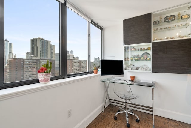 office space featuring dark parquet floors and a healthy amount of sunlight