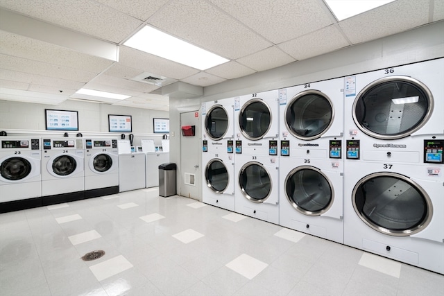 clothes washing area featuring washer and dryer and stacked washer and dryer