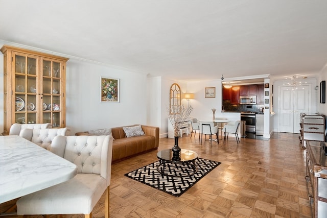 living room with crown molding and light parquet floors